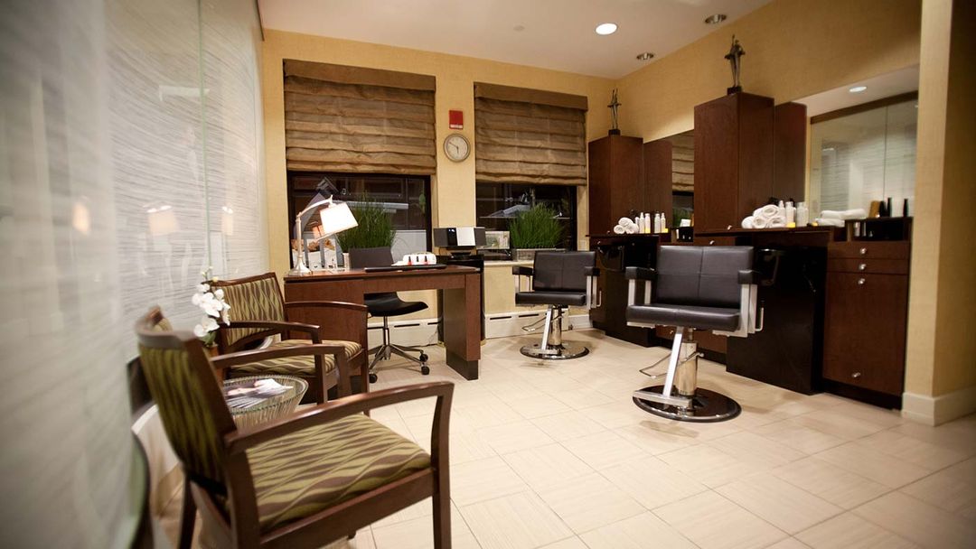 Caregiver assisting resident in assisted living facility with hair care routine