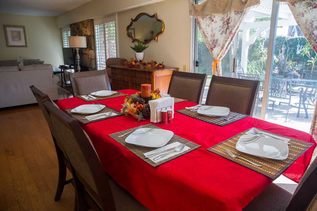 Senior living community dining room at Ocean Breeze Estates at Beechwood with elegant furniture and decor.