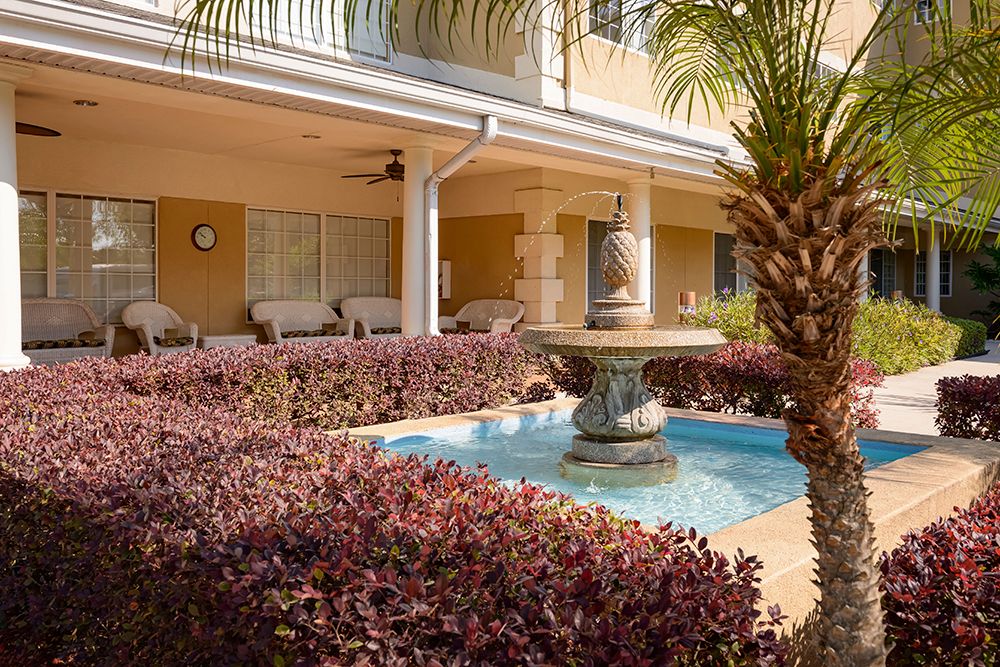 Senior living community, The Bridge at Ocala, featuring a villa-style resort with pool and lush greens.