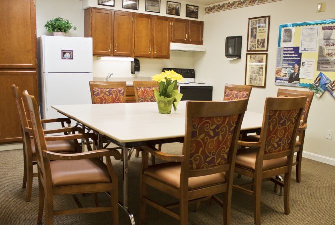Senior residents enjoying mealtime in the dining room at Marquis Gardens Place with modern amenities.