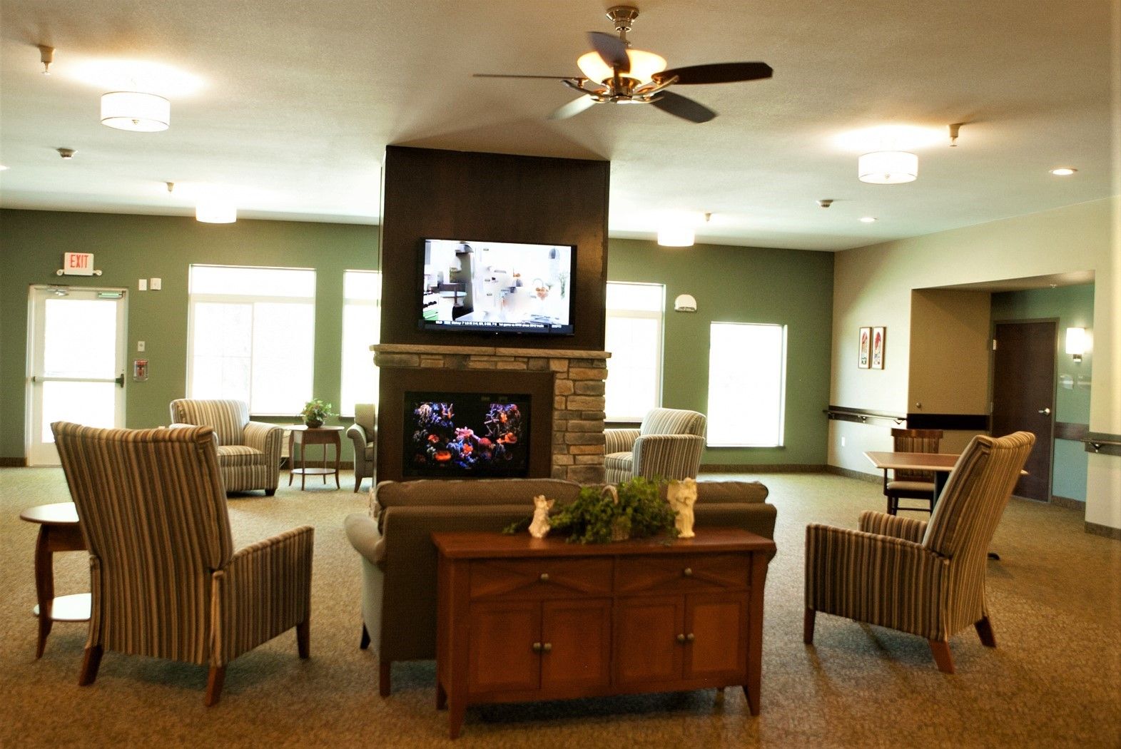 Sensory stimulation can be found within The Koselig Home through the use of sound, smell, touch, and this sitting area features our visually engaging fish tank.