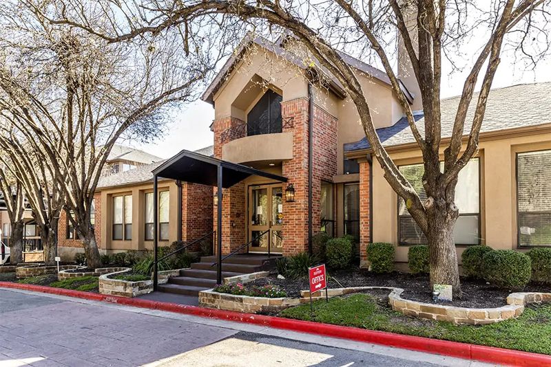 Continental Retirement Community architecture in an urban suburb with houses, cars, and portico.